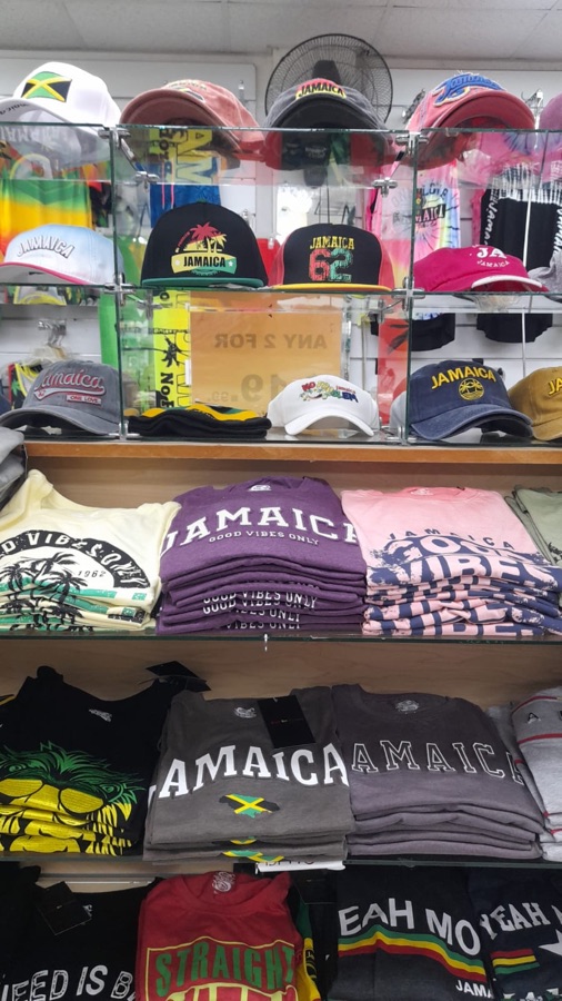 Display shelves of Jamaica caps and folded Good Vibes t-shirts