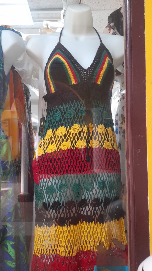 Handcrafted Rasta-colored crochet dress on a mannequin