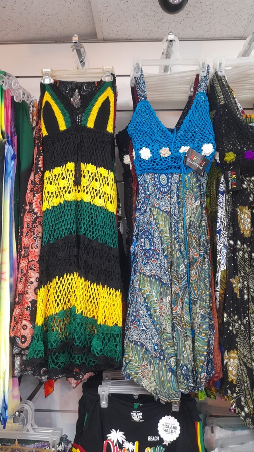 Handcrafted Rasta-colored crochet dresses on display